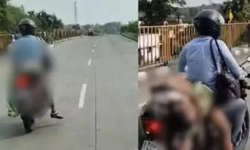 സഹായത്തിന് ആരും എത്തിയില്ല; റോഡപകടത്തില്‍ മരിച്ച ഭാര്യയുടെ മൃതദേഹം ബൈക്കില്‍ കെട്ടി കൊണ്ടുപോയി യുവാവ്